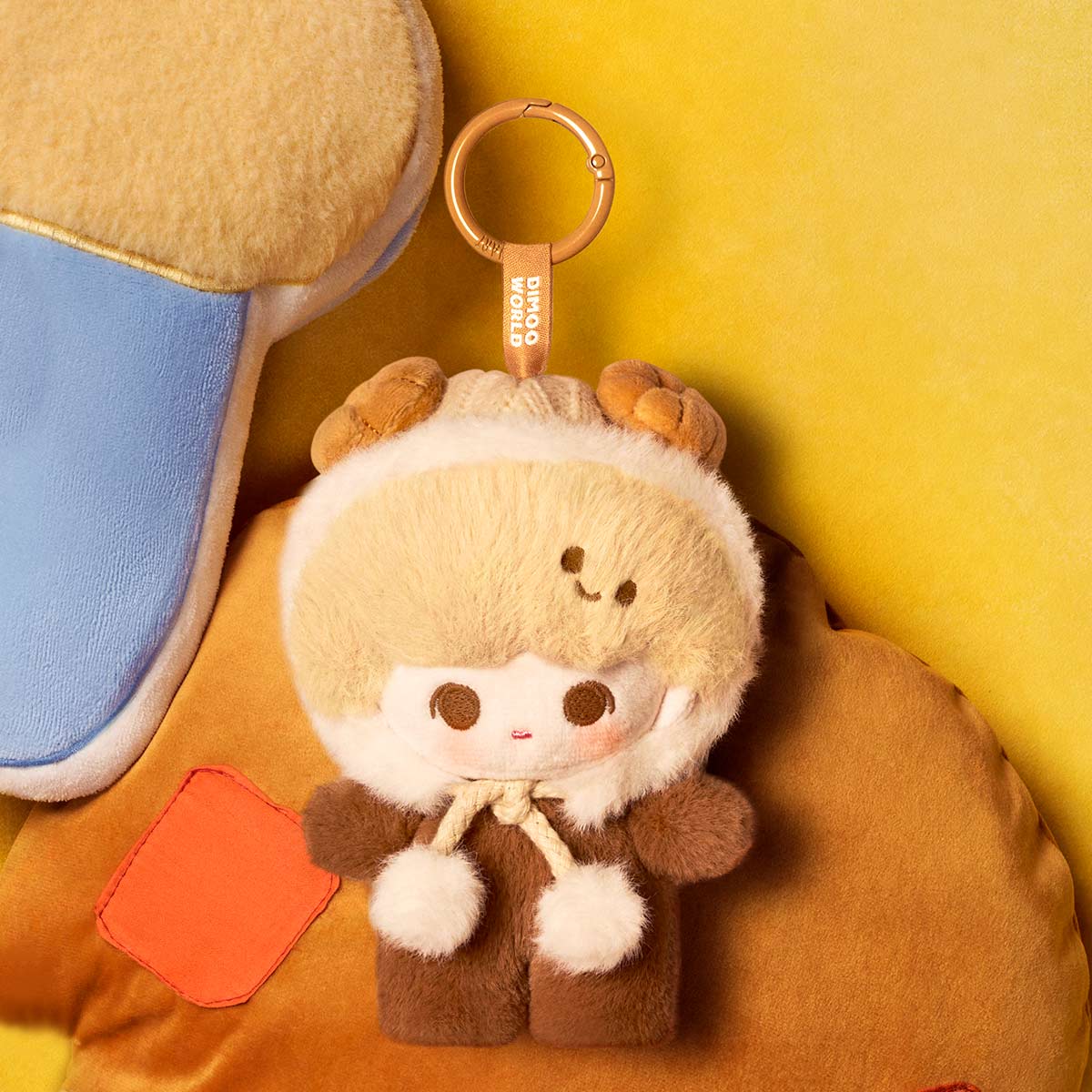 Plush keychain with a cute design on a yellow background